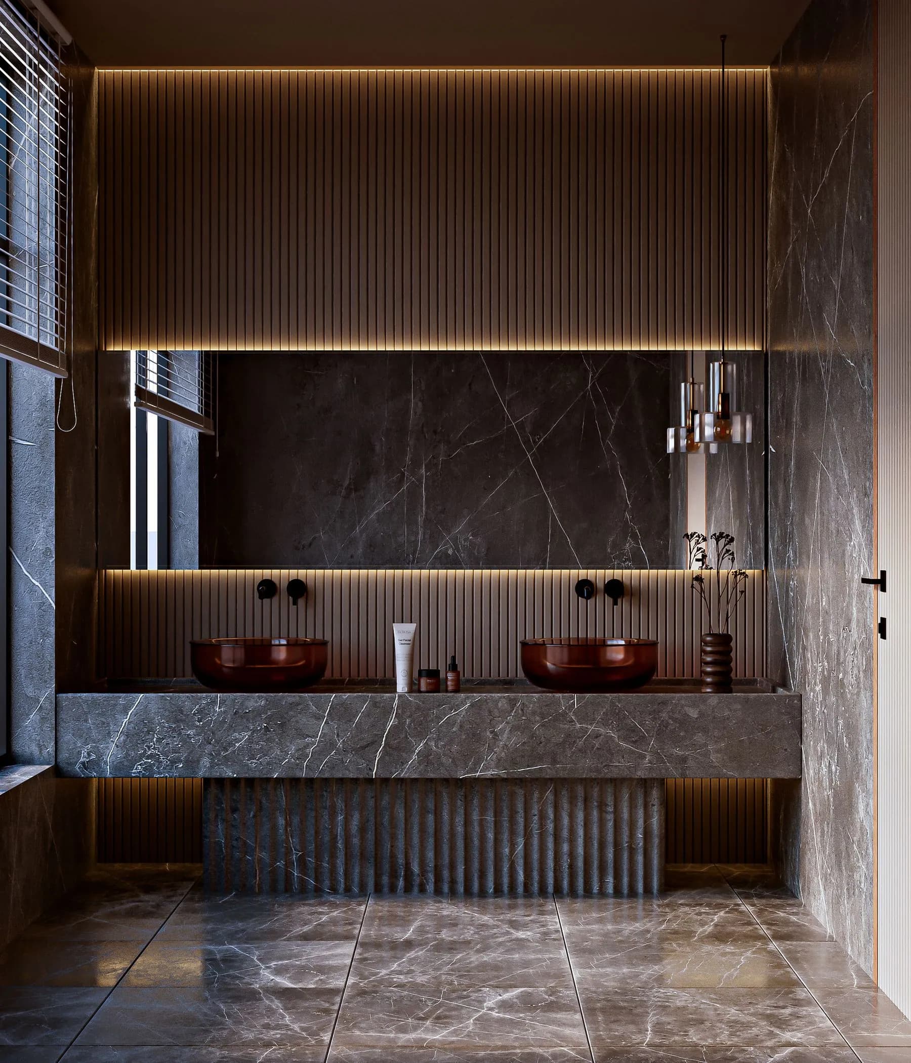 Double vanity in a thick stone slab with reeded panelling above and below, lit by an LED shadow gap
