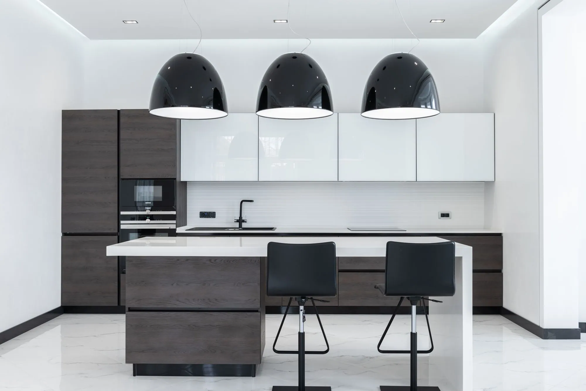High-gloss white wall units above a textured wood-effect island with a thin white counter