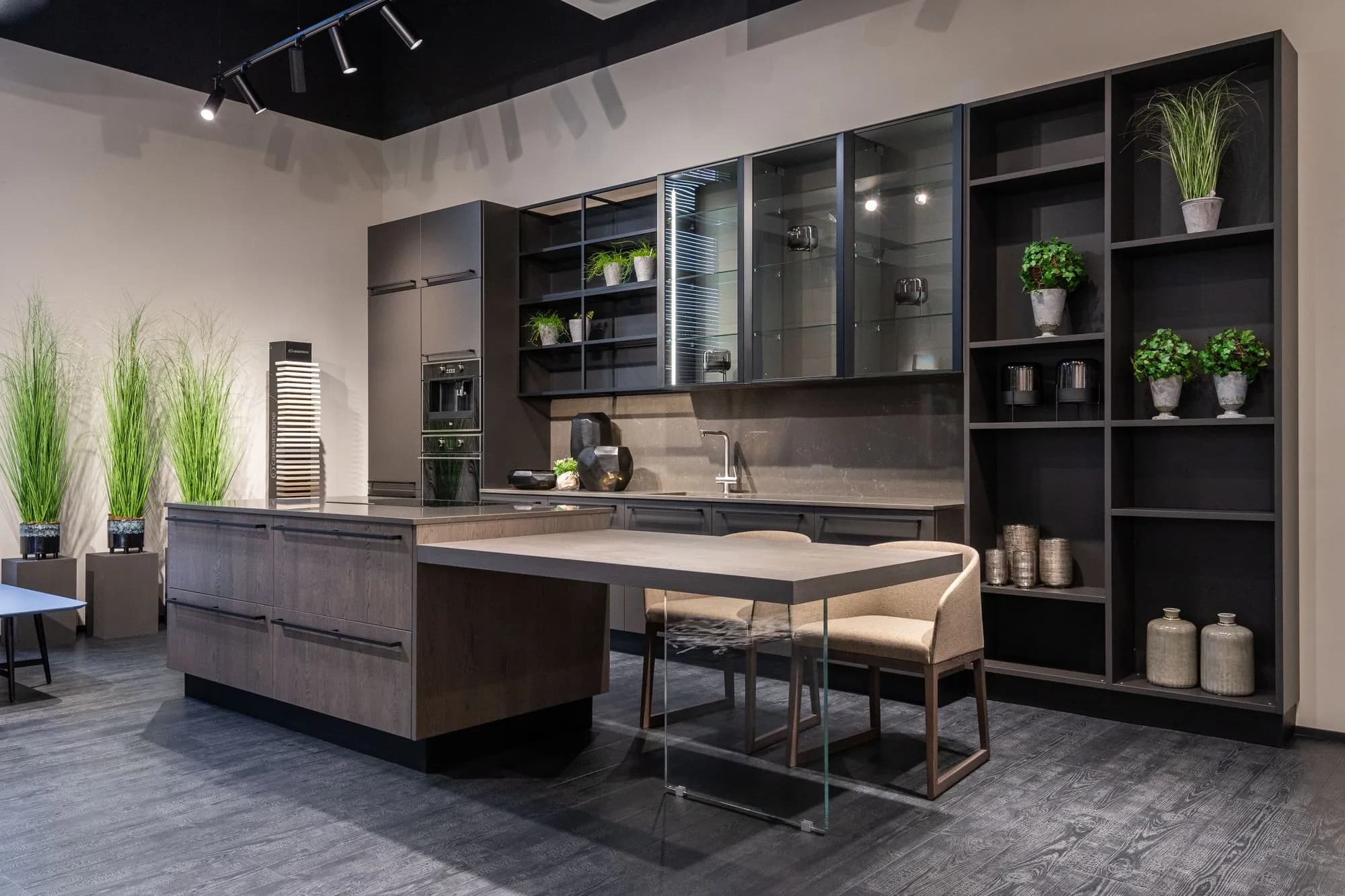 Dark handleless cabinetry with open shelving above a stone island
