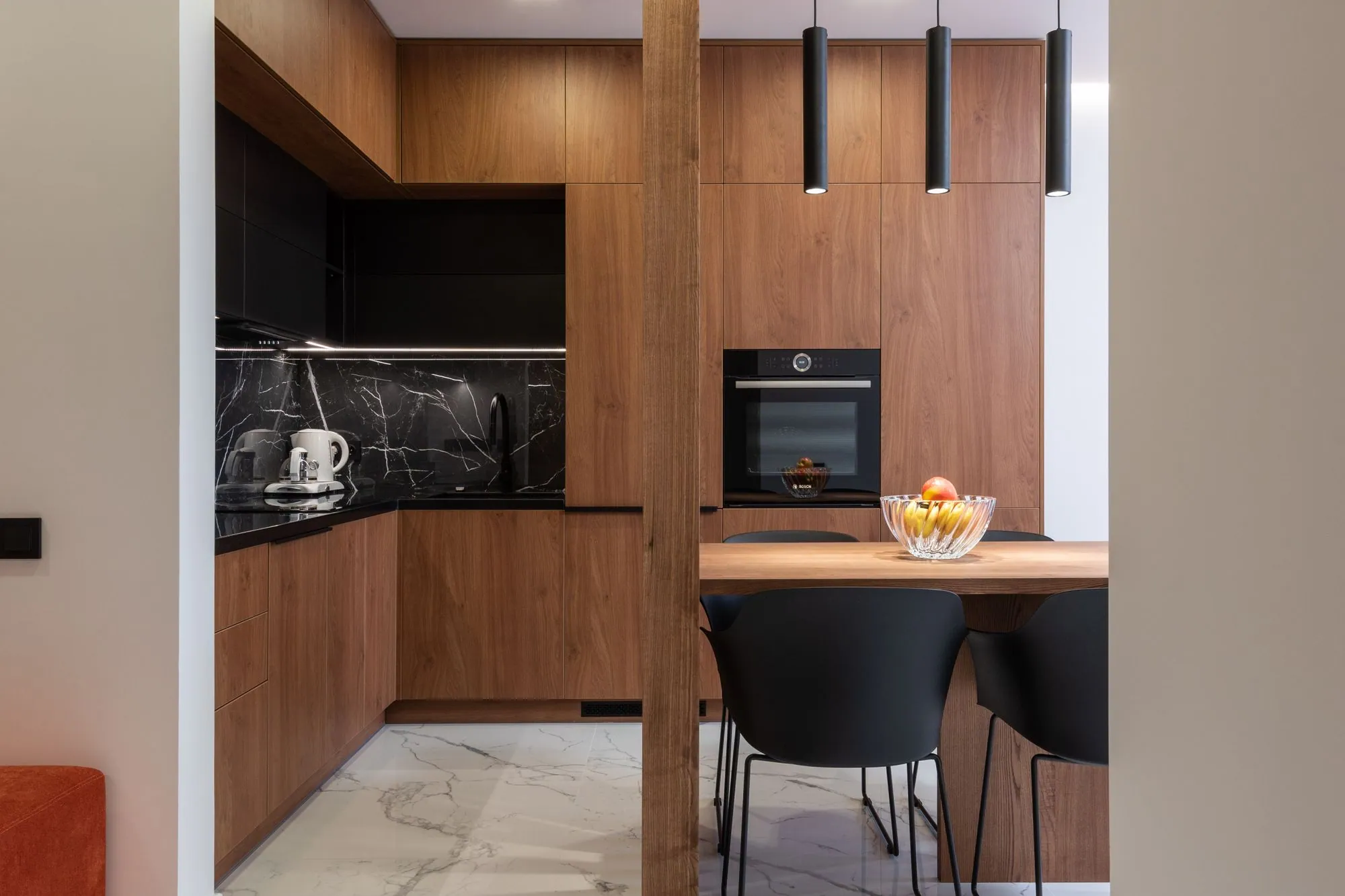 Continuous-grain oak veneer carried from the base drawers up through a full-height oven housing