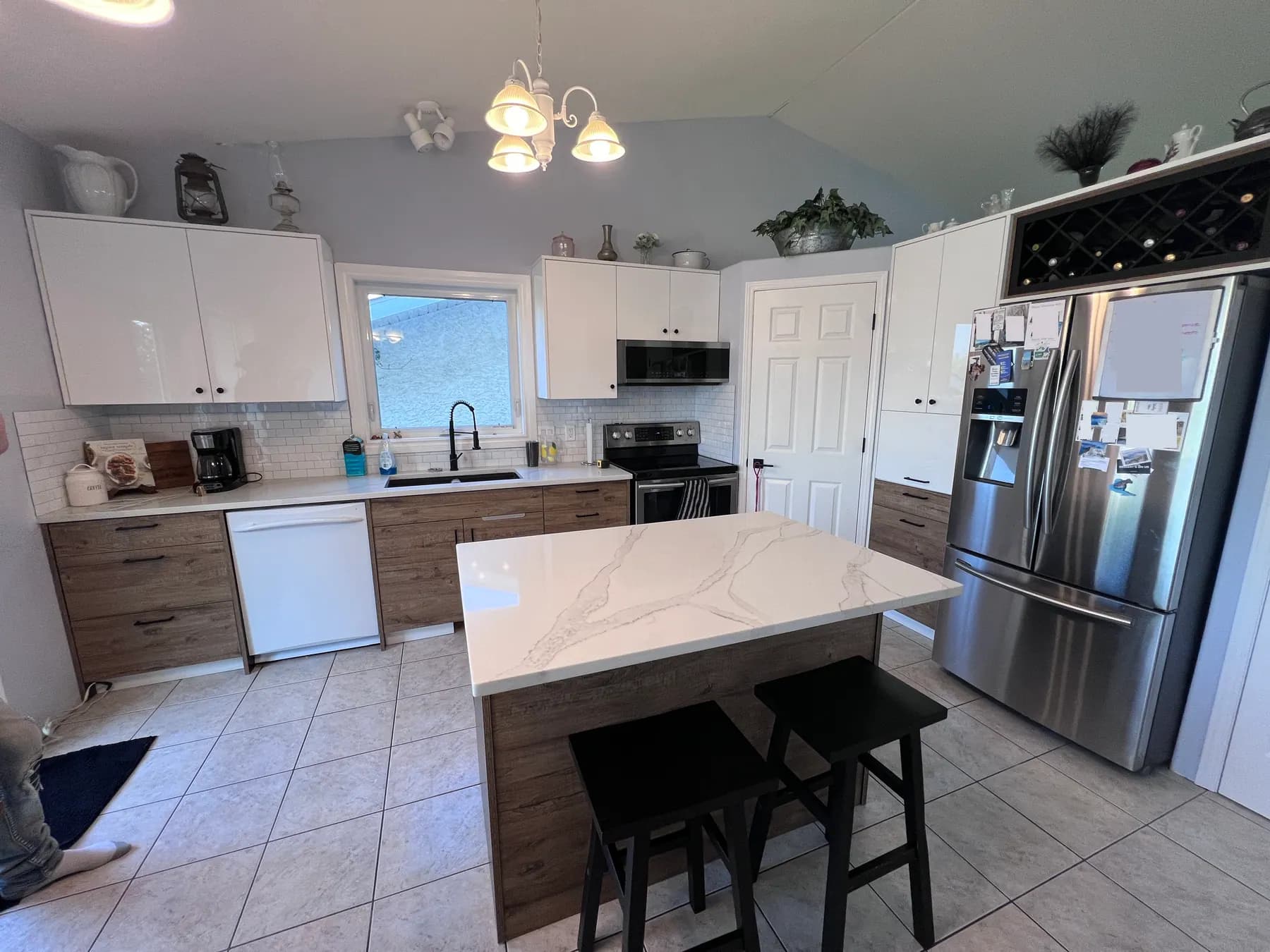 Quartz island with a mitred waterfall end and stools set under the overhang