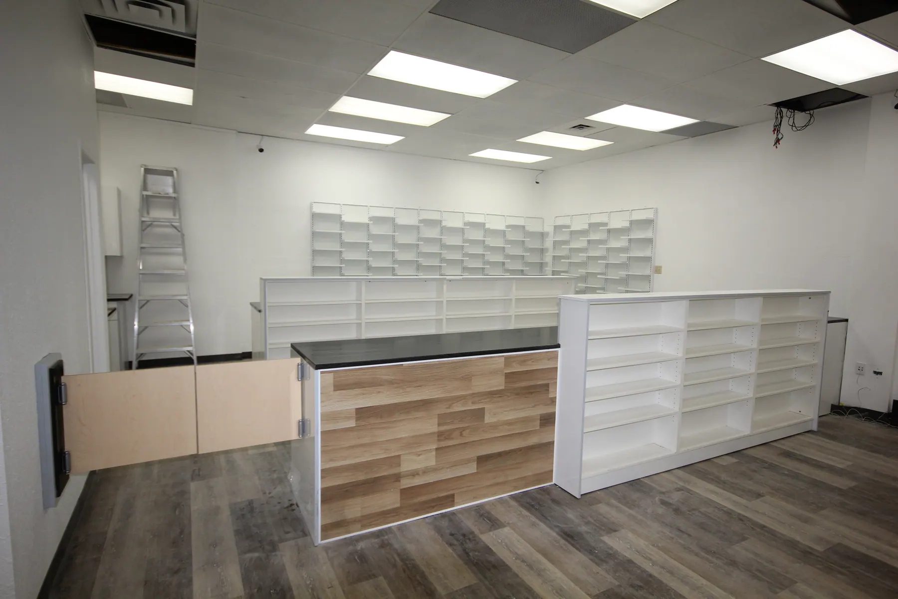 Retail floor with open shelving units and the service counter beyond