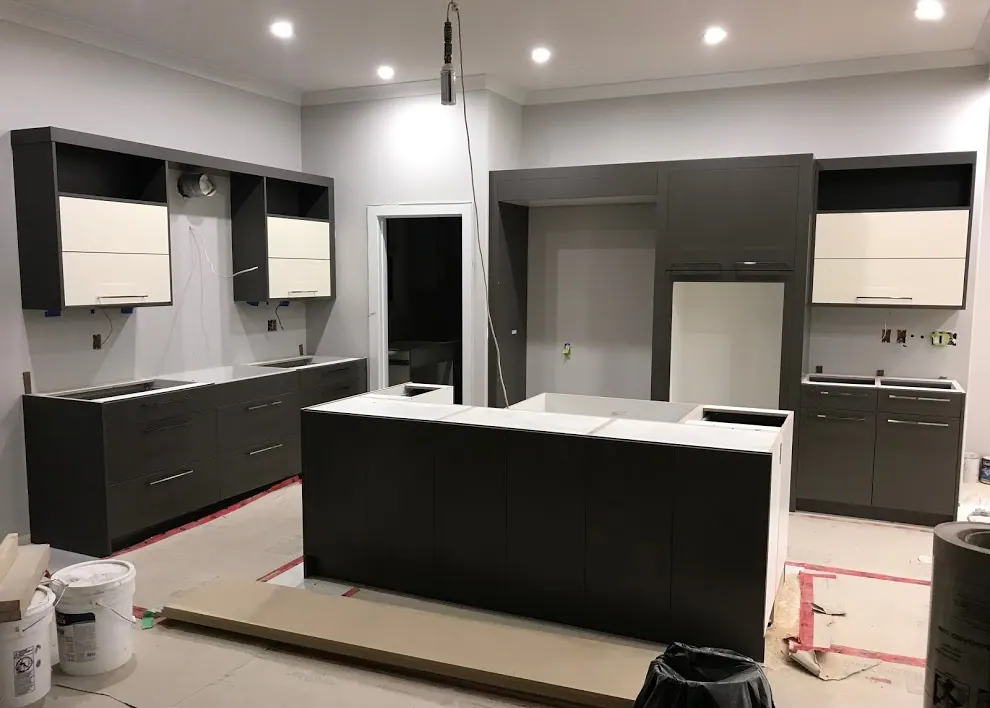 The same kitchen during installation, with the island fronts hung and the counters not yet fitted
