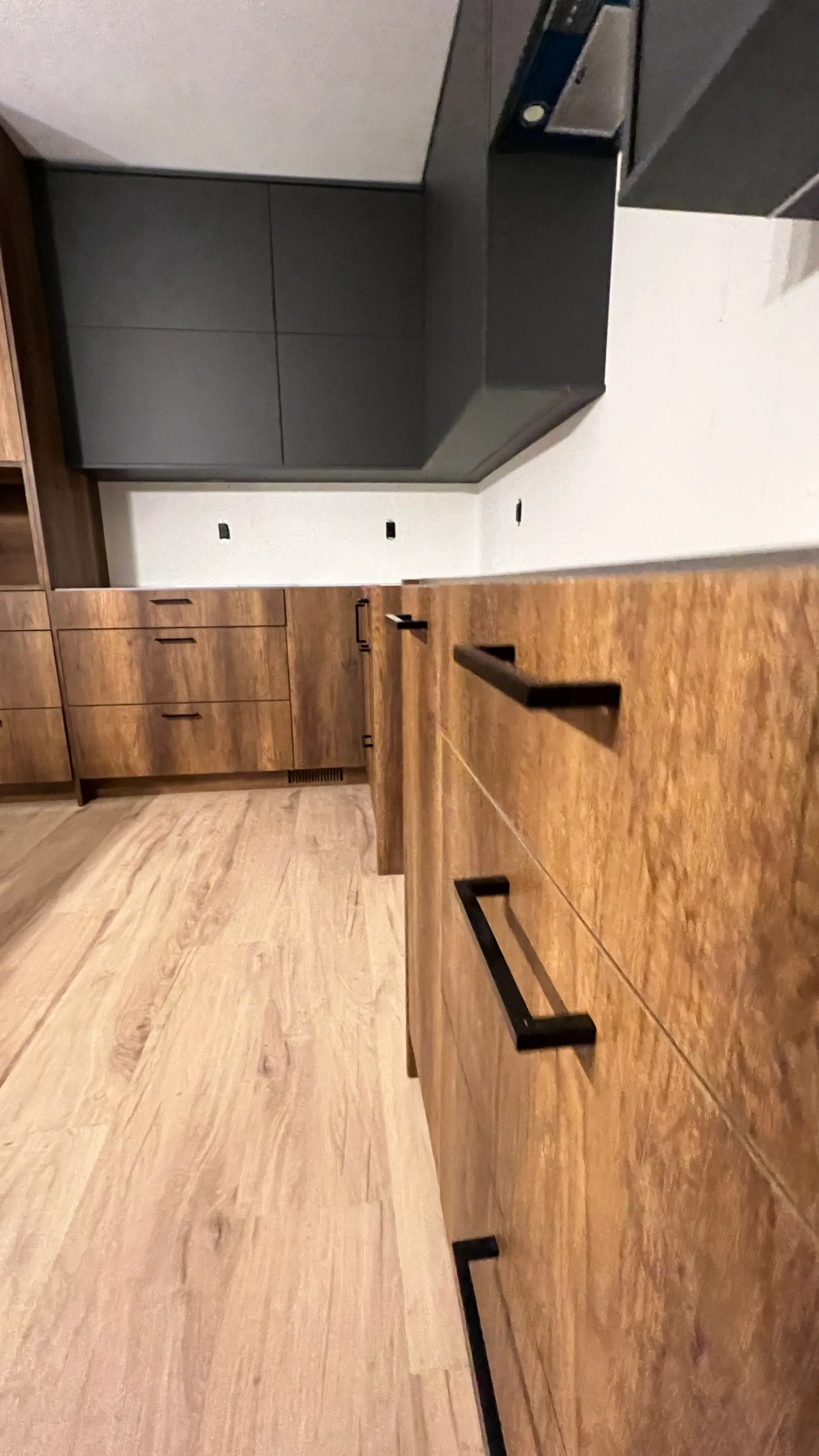 Walnut-look drawer fronts with black bar pulls set horizontally