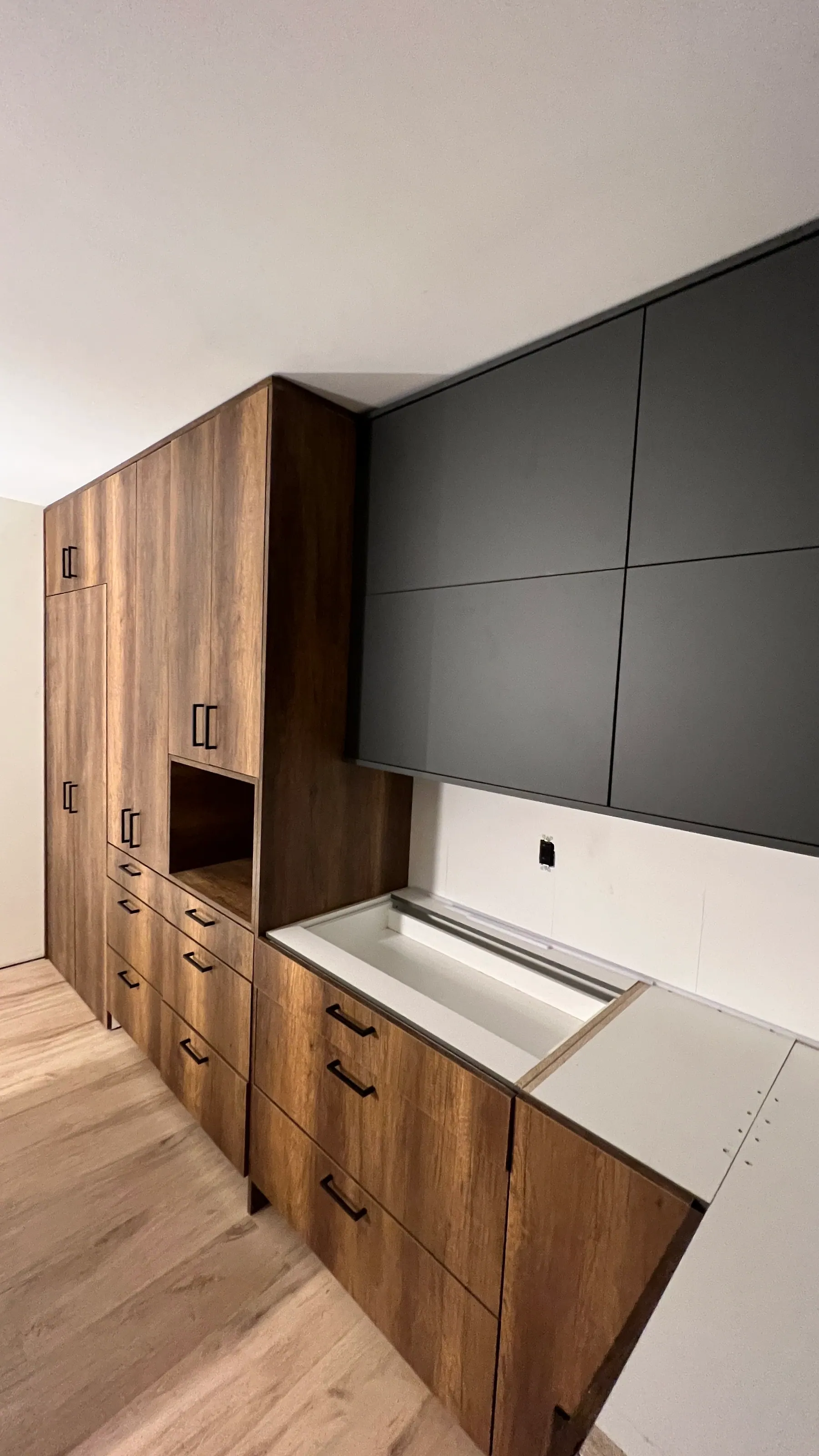 Tall units carried to the sloped ceiling on the range wall