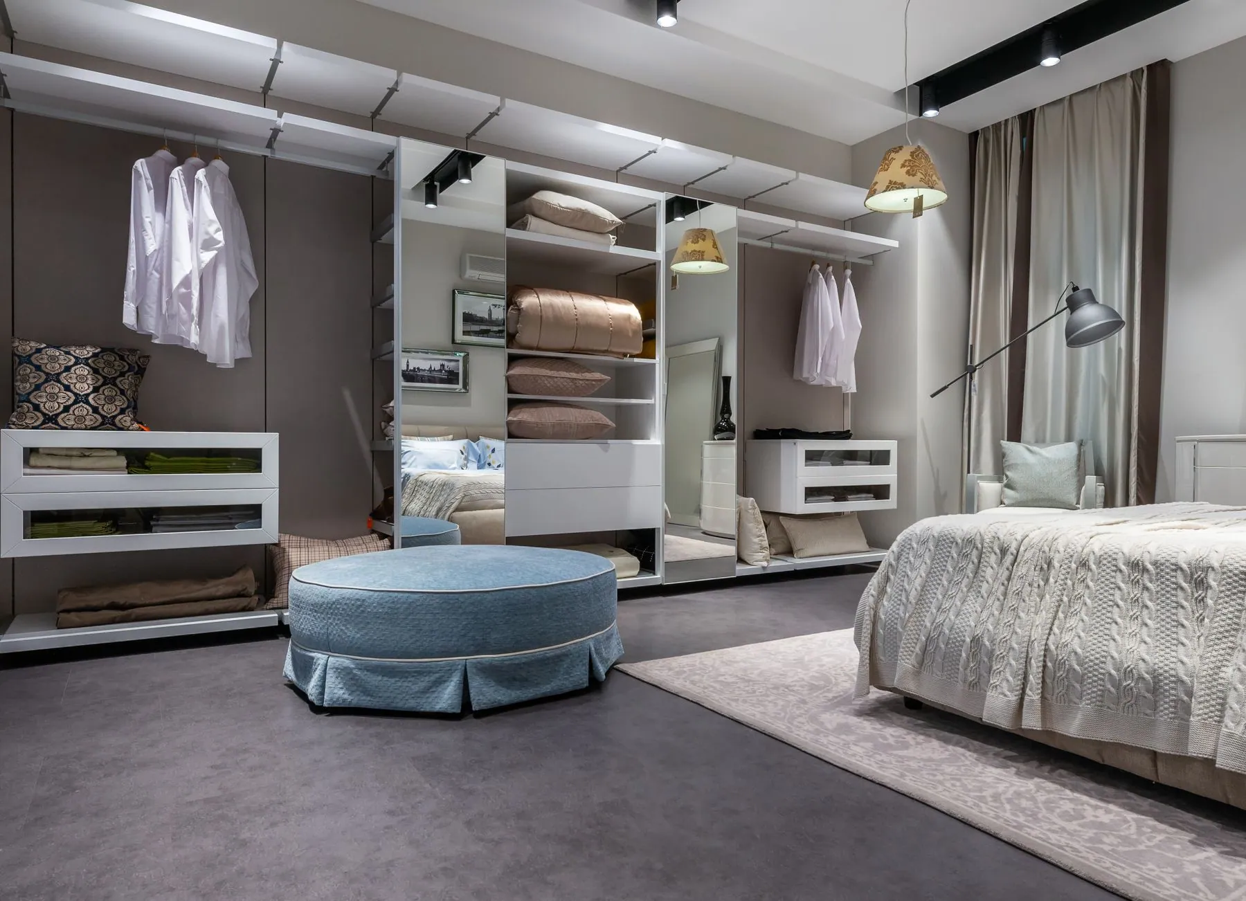 Guest bedroom with a shallow handleless wardrobe in soft green matte lacquer beside a low bulkhead