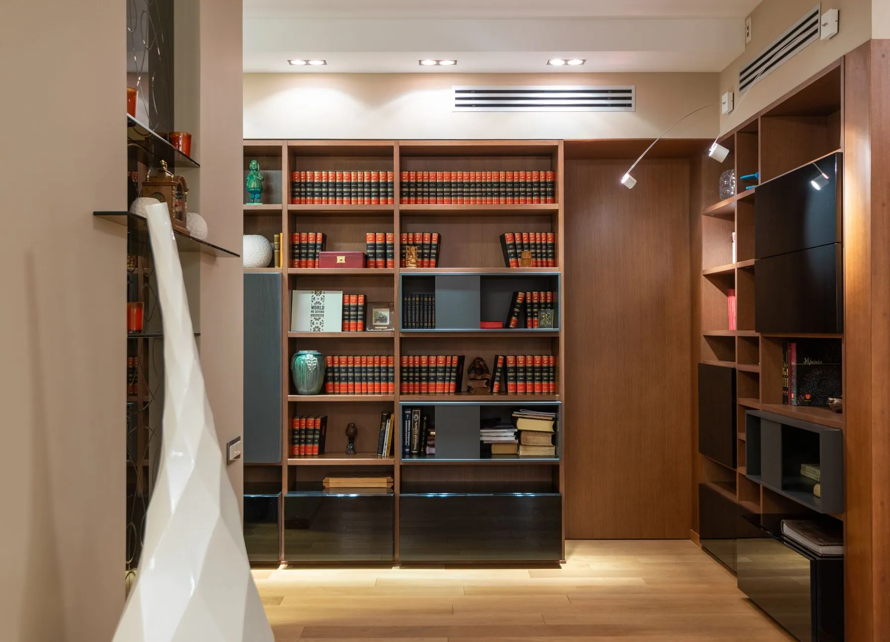 Handleless storage drawers cut into the side of a staircase and finished flush with the stringer