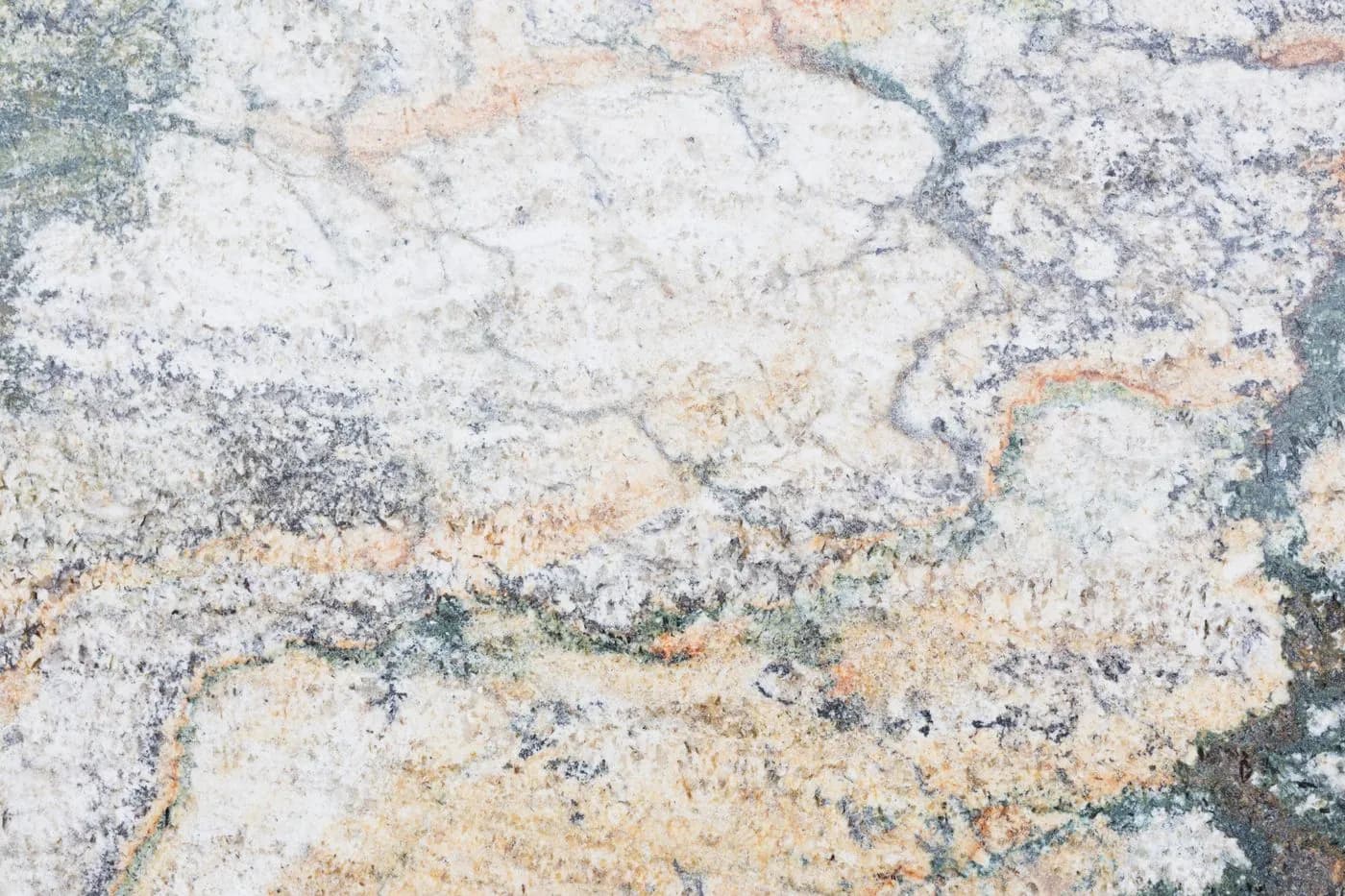 Close-up of a speckled stone slab under consideration for a laundry counter