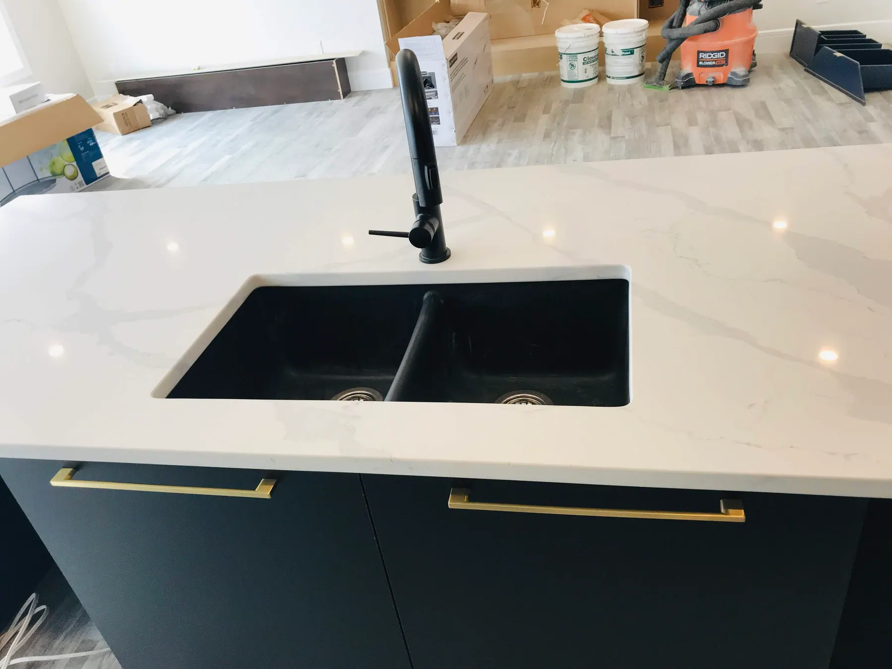 Vanity drawer bank with brass pulls and an undermount basin