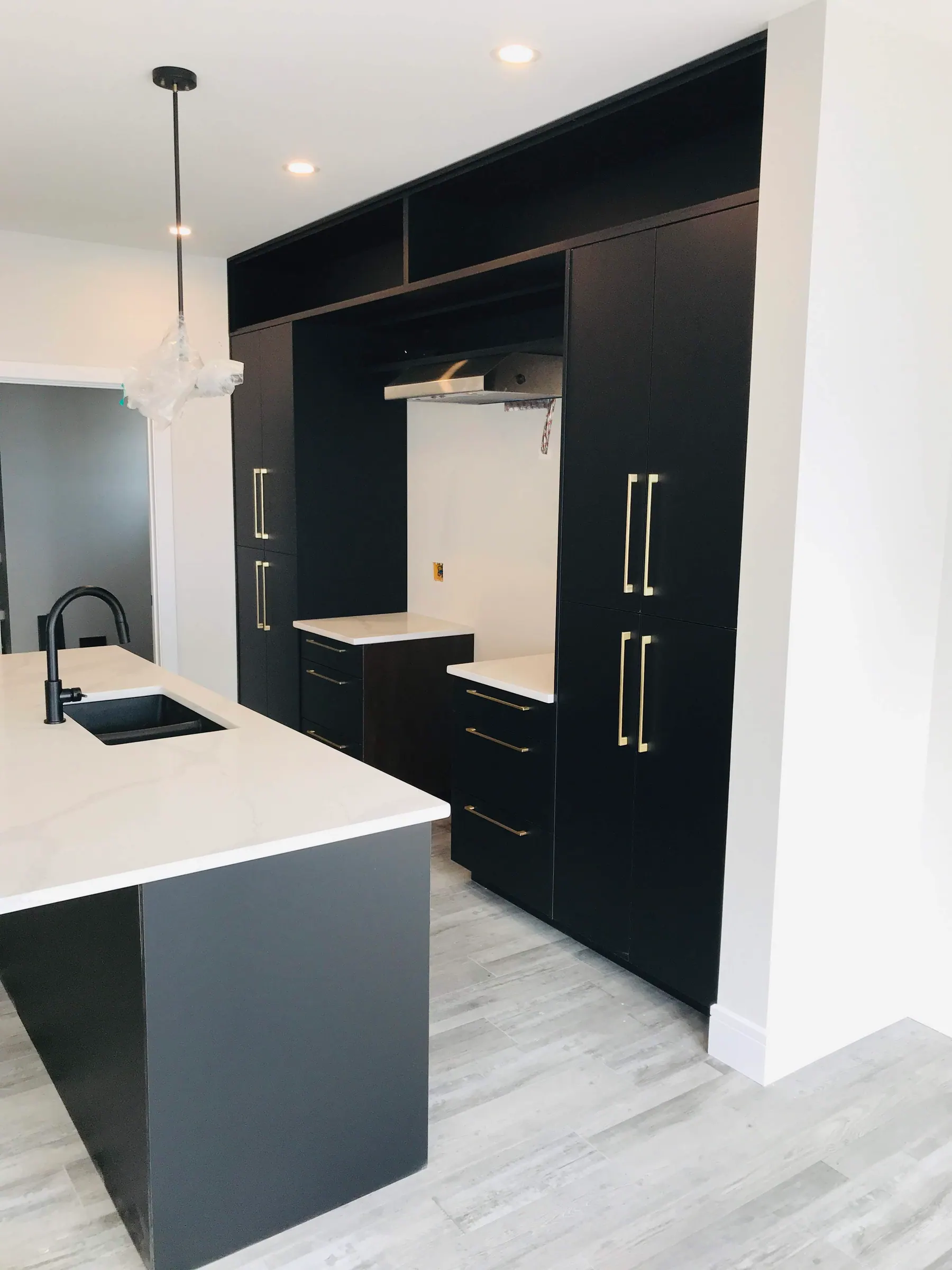 Vanity with a black tap against white quartz