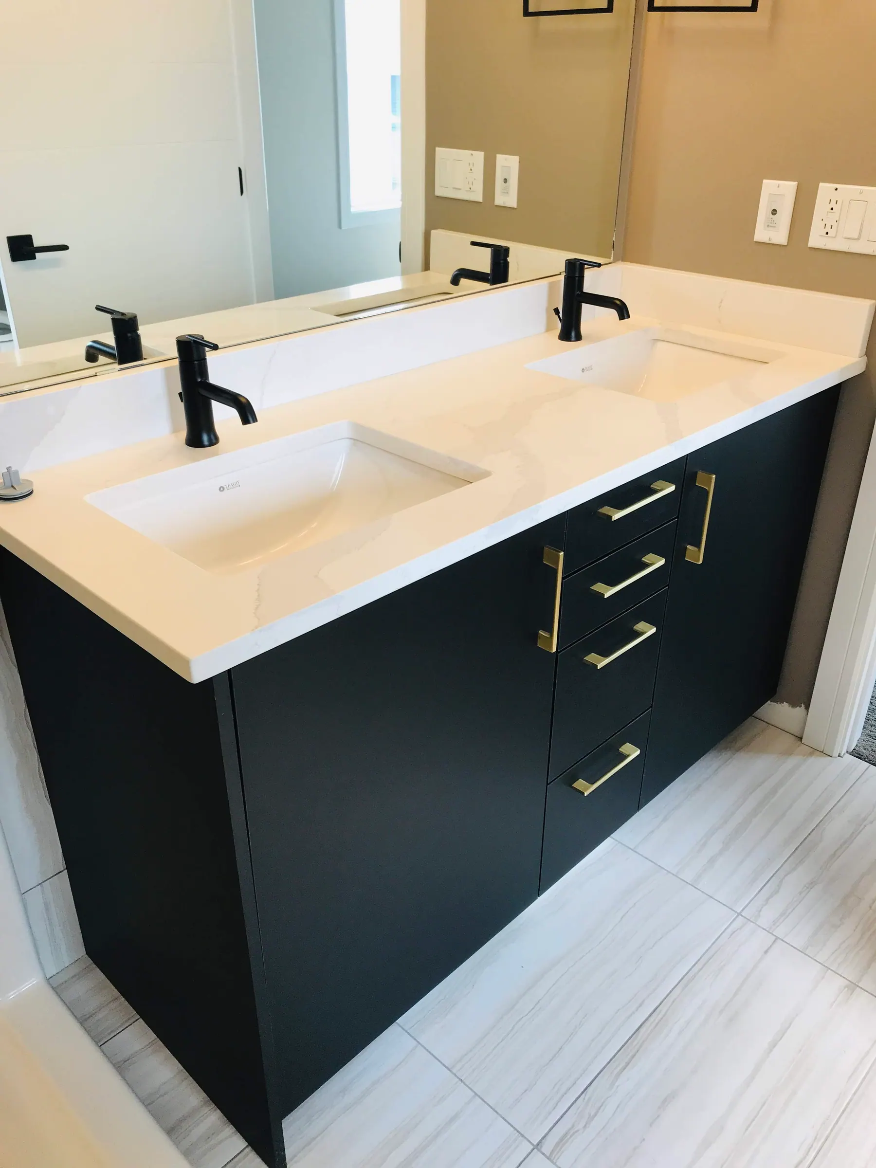 Island sink detail with brass pulls on the drawer fronts below
