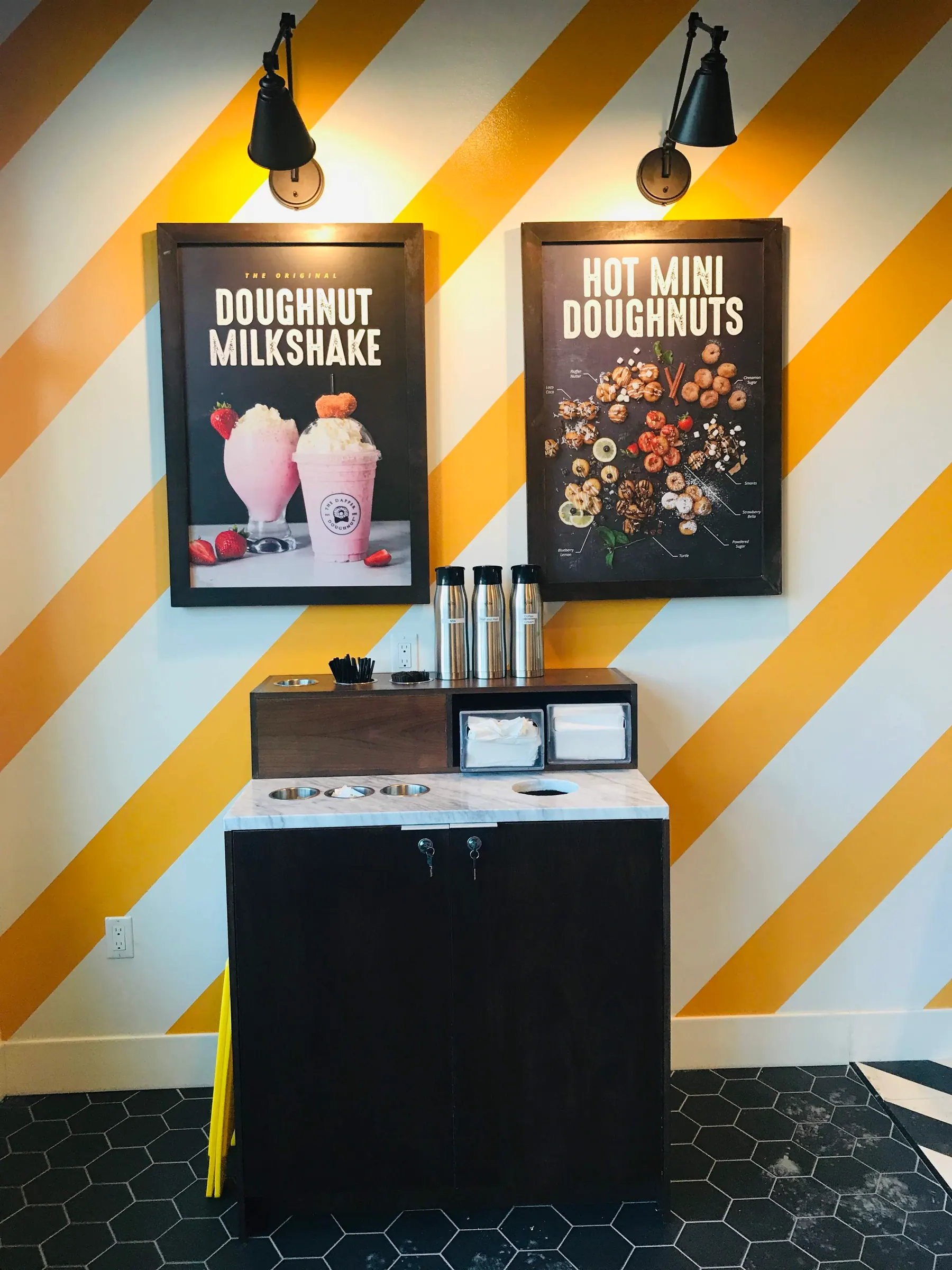 Condiment station in walnut with a stone top against the striped brand wall