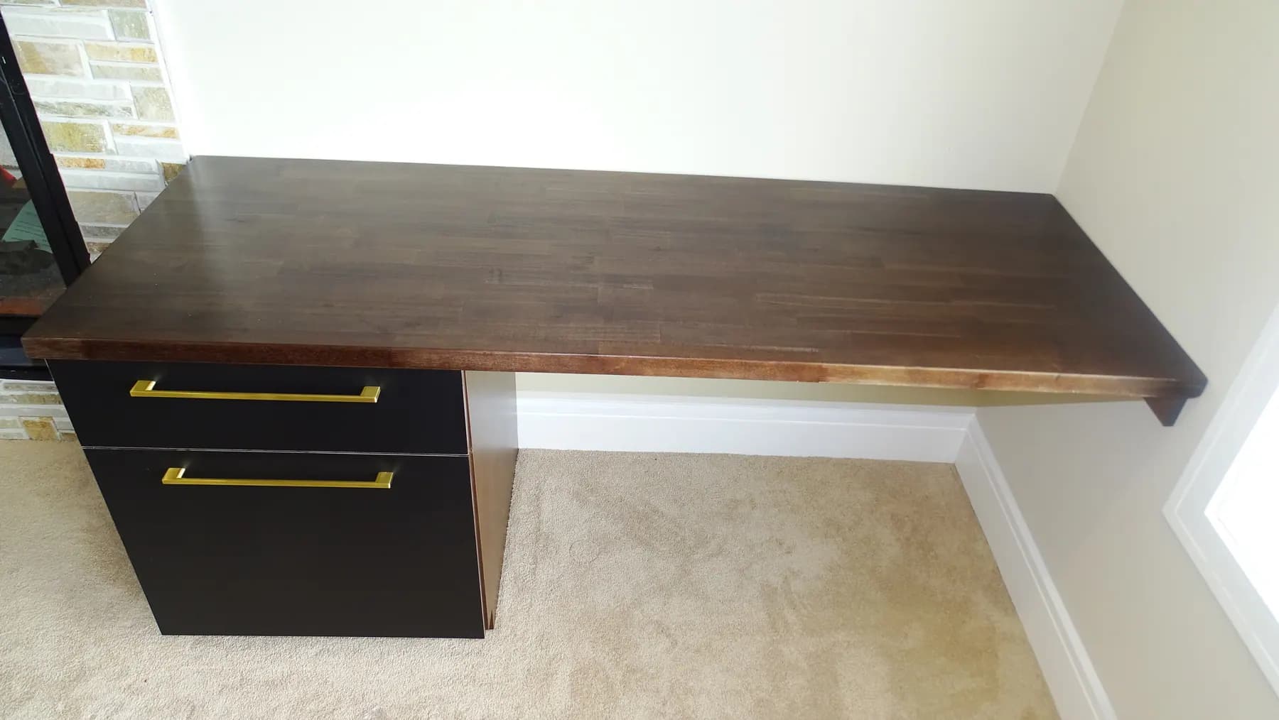 Study desk on a solid timber top over an espresso drawer pedestal with brass pulls
